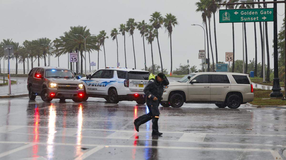 Police block the entrance to the John Ringling Causeway leading to Lido Key off the coast of Sarasota as the outer bands of Hurricane Milton on Wednesday, Oct. 9, 2024. People were not allowed to go the key, but the route off the key toward the mainland remains open for any last minute evacuees.