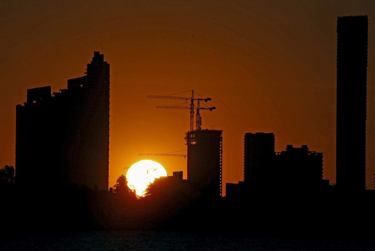The sun sets over buildings near Biscayne Boulevard in Miami, Florida, on April 1, 2020.
