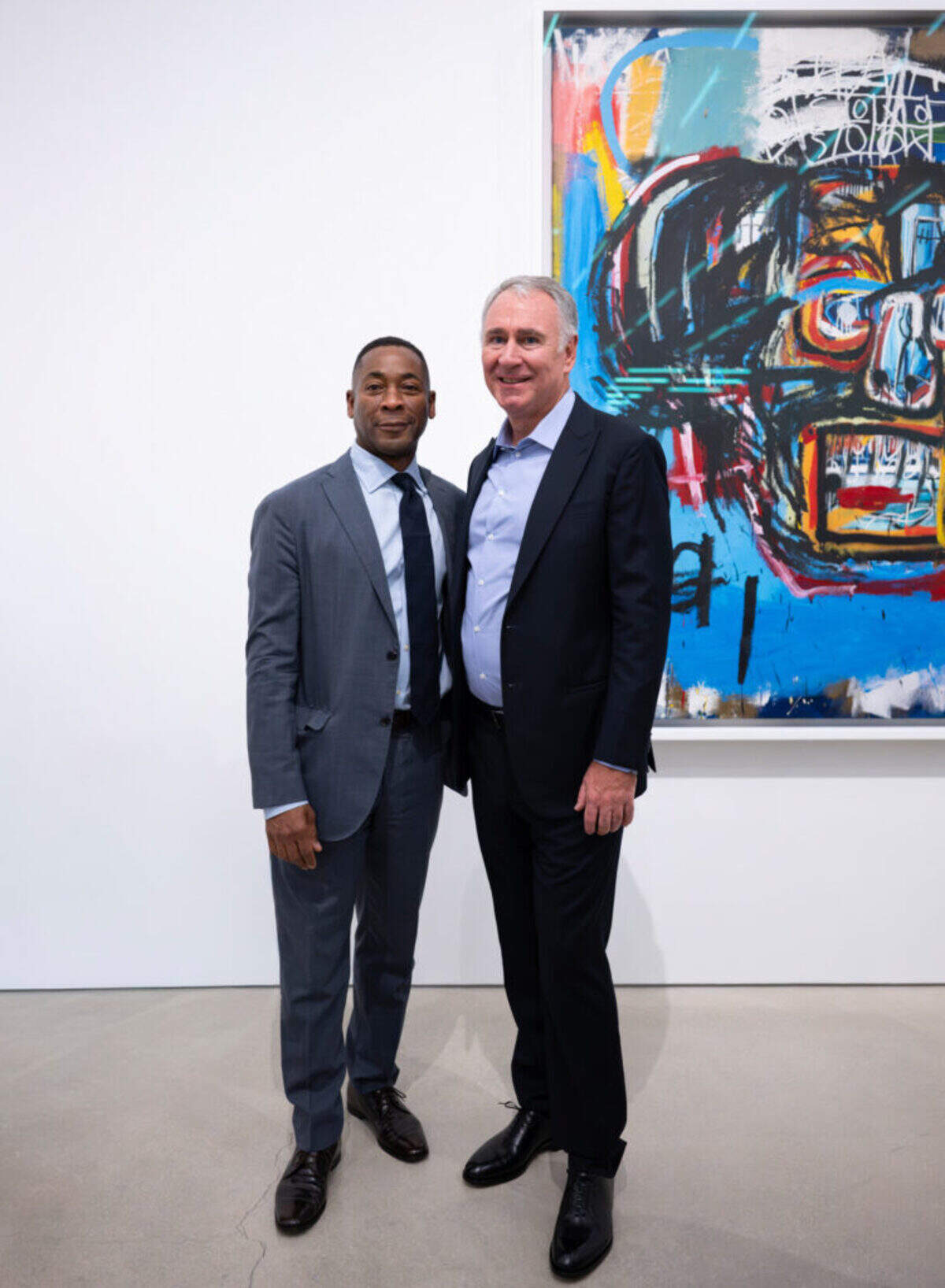 Collector Kenneth C. Griffin, right, and Pérez Art Museum Miami Director Franklin Sirmans stand in front of Jean-Michel Basquiat’s “Untitled” (1982), one of the centerpiece works in “Basquiat: Figures, Signs, Symbols,” the first public exhibition drom the Kenneth C. Griffin Collection now at PAMM.