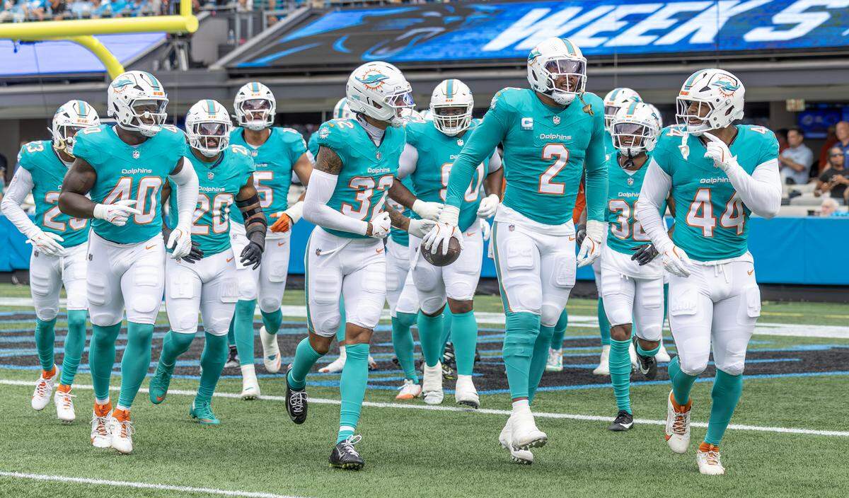 Miami Dolphins outside linebacker Bradley Chubb (2) celebrates with teammates after forcing and recovering a fumble by Carolina Panthers quarterback Bryce Young (9) during the first half of an NFL game Sunday, Oct. 5, 2025, at Bank of America Stadium in Charlotte, N.C.