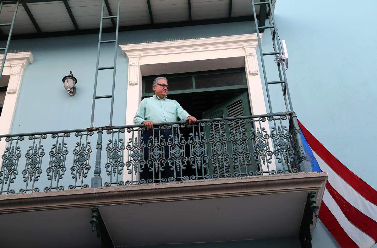 Javier Santiago, director of the National Foundation for Popular Culture, stands on the balcony of the foundation’s building located in the corner of La Fortaleza street leading to the governor’s mansion.