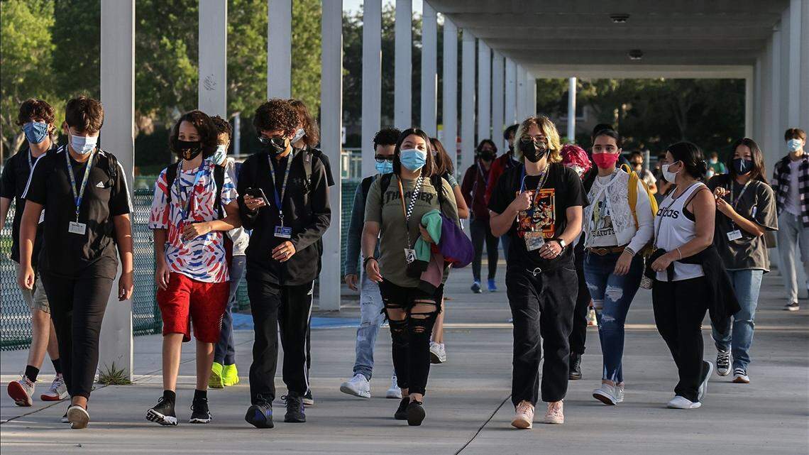 Broward Cypress Bay High School students enter campus as they returned back to school under a school board mask mandate on Wednesday, August 18, 2021.