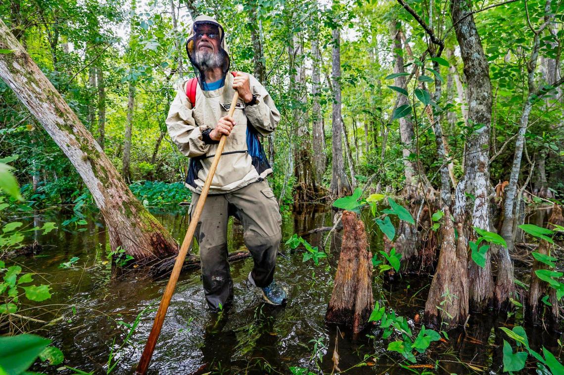 Trail guide John Kalafarski wears a bug shirt to fend off mosquitoes as he walks a trail in the Everglades near the so-called “Alligator Alcatraz.” Kalafarski and others who live and work in the area think people have a misconception about the Everglades. They call it home.