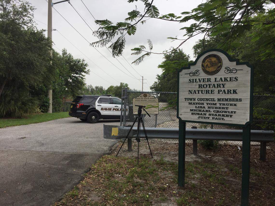 Davie Police set up a staging area at Silver Lakes Rotary Nature Park as officials search for a woman who went missing as she walked her dogs near the pond on June 8, 2018. Witnesses spotted an alligator in the water, and one of the woman's dogs had fresh wounds.