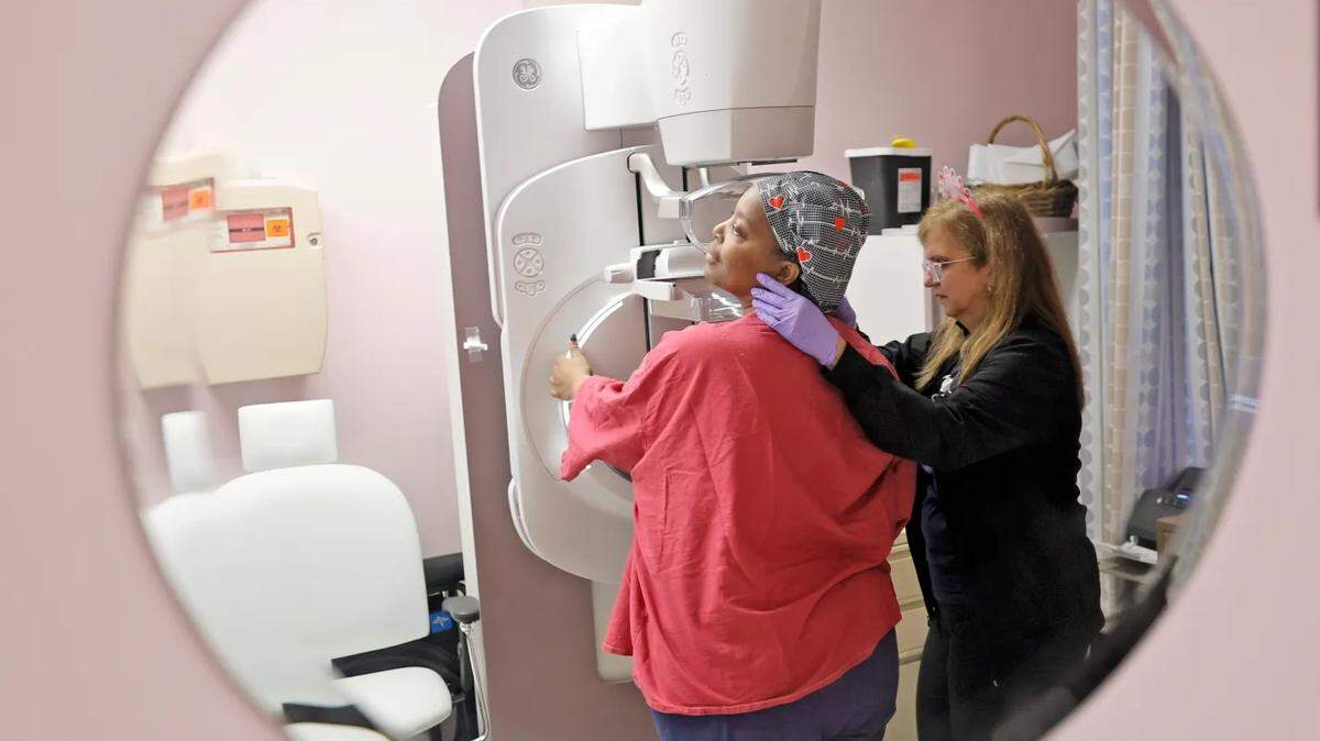 A mammographer positions a woman for scans during a Mammo-Glam mammogram event at HCA Florida Westside Hospital in Plantation on Oct. 23, 2024.