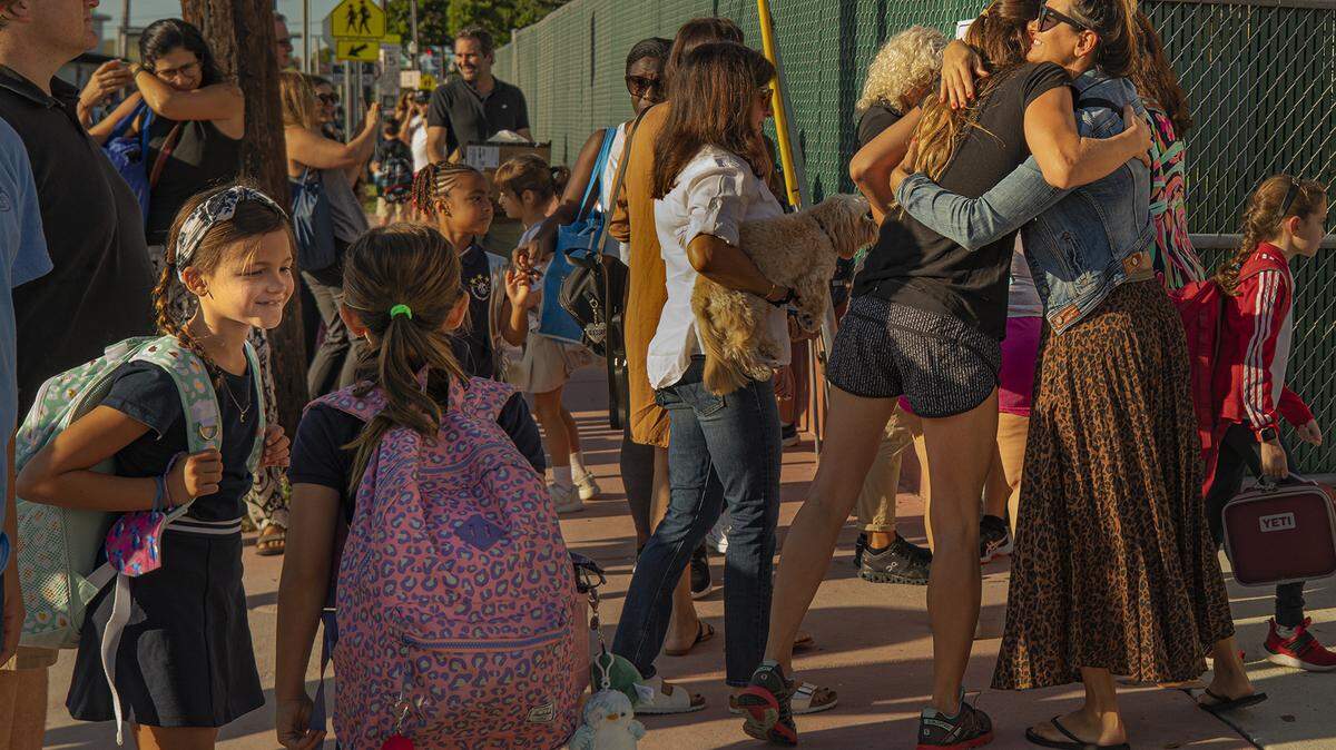 Students and parents greet each other before entering North Beach Elementary in Miami Beach, Florida, on the first day of school Aug. 17, 2022. The first day of school for Miami-Dade Public Schools is Thursday, Aug. 17, 2023, for the 2023-24 school year.