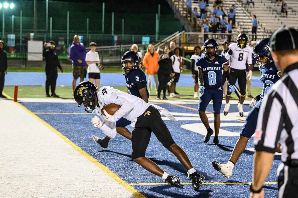 Western High School Wide Receiver Khamarian Young (14) scores a touchdown during the game at Tropical Park on Friday, Nov. 15, 2024 in Miami, Fla. (Ruben Gonzalez/Miami Herald)