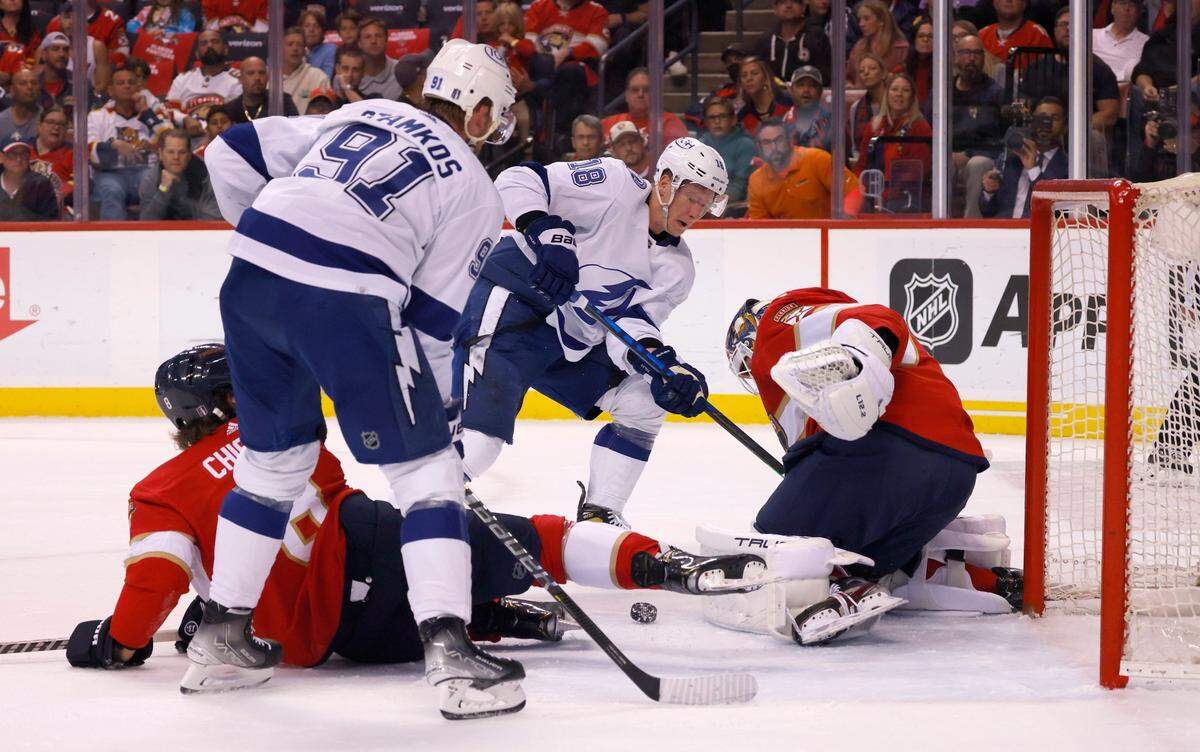 Florida Panthers defenseman Ben Chiarot (8) looks on as Panthers goaltender Sergei Bobrovsky (72) makes a stop against Tampa Bay Lightning center Steven Stamkos (91) and left wing Ondrej Palat (18) during the first period of Game 1 of an NHL hockey second-round playoff series Tuesday, May 17, 2022, in Sunrise, Fla. (AP Photo/Reinhold Matay)