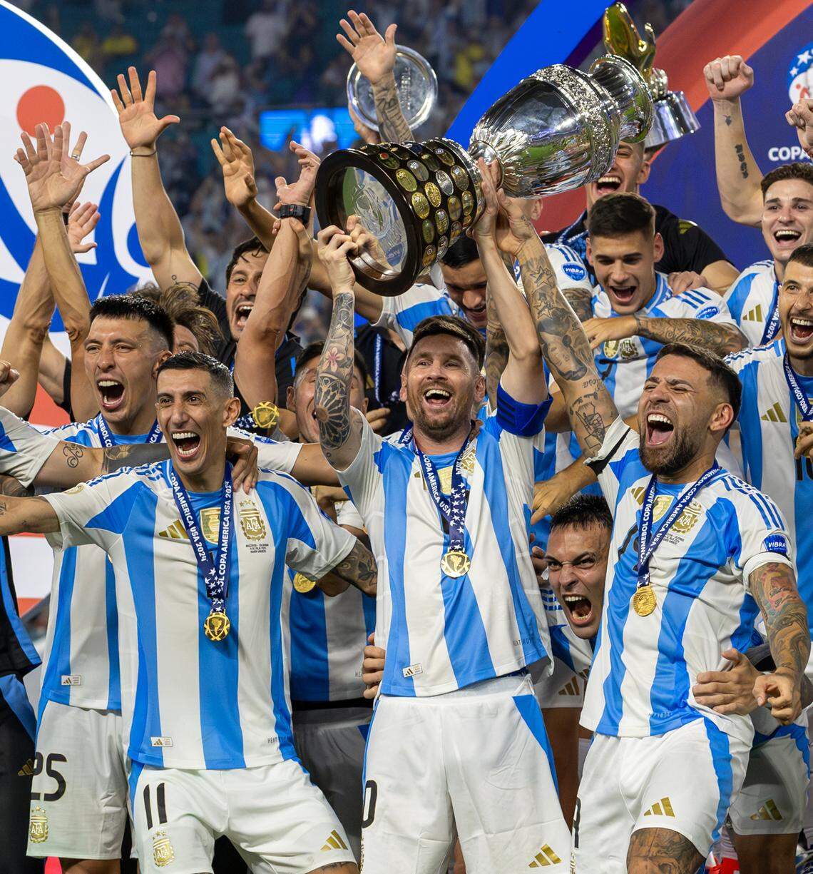 Argentina forward Lionel Messi (10) holds the trophy with his teammates after defeating Colombia in their Copa America 2024 Final soccer match at Hard Rock Stadium on Sunday, July 14, 2024, in Miami Gardens, Fla.