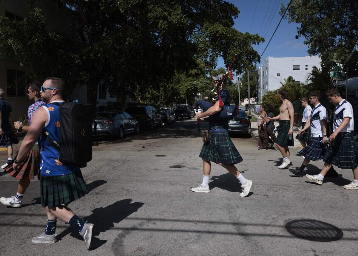 A bagpipe player and other Scotland fans wearing kilts march down 15th Ave from Calle Ocho to loanDepot Park, where the Miami Marlins play, during a gathering of Tartan Army, Scottish National Football team fans, on Monday, June 22, 2026, in Miami, Fla.