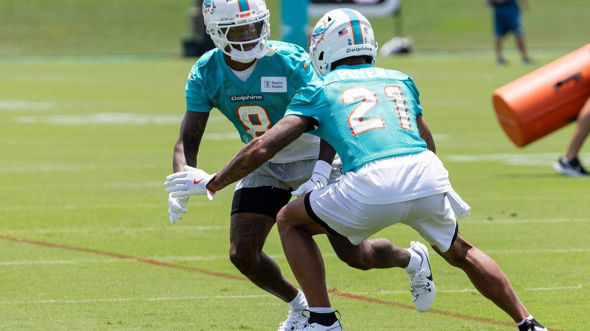 Miami Dolphins safeties Jevon Holland (8) and Jordan Poyer (21) run drills during a team practice session at the Baptist Health Training Complex on Tuesday, May 21, 2024 in Miami Gardens, Fla.