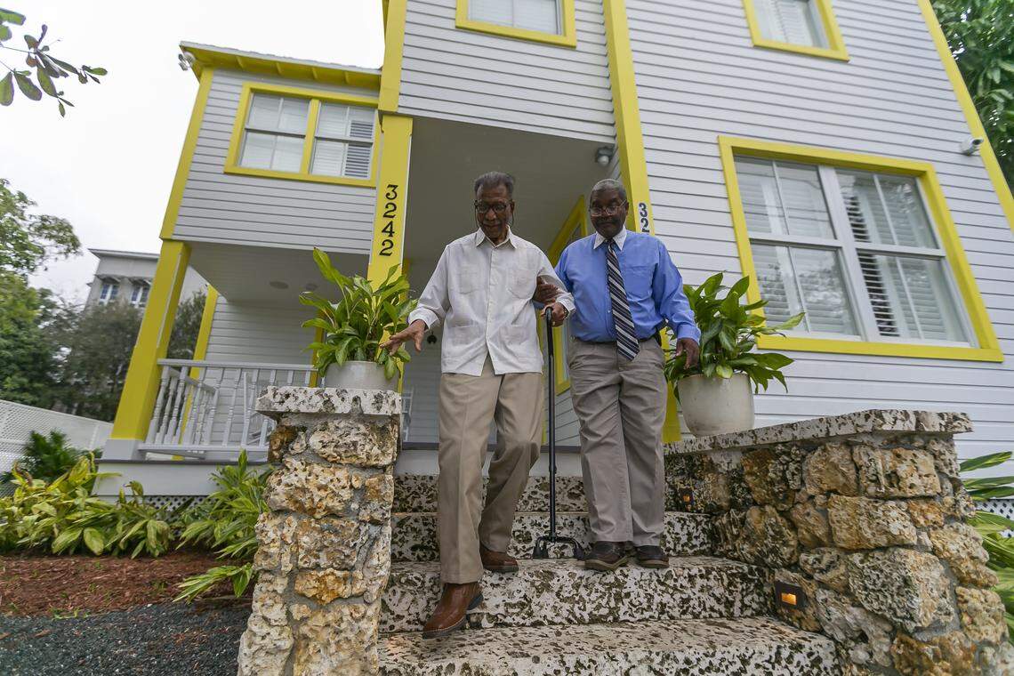 George Simpson, right, and his father, Dr. George Simpson, whose family owns the 1897 E.W.F. Stirrup House in historically Black West Coconut Grove, have restored the home with the help of development partners. The historic home is open as a lodging and event space while the partners work on a plan to build a companion, island-style inn on lots they own across the street.