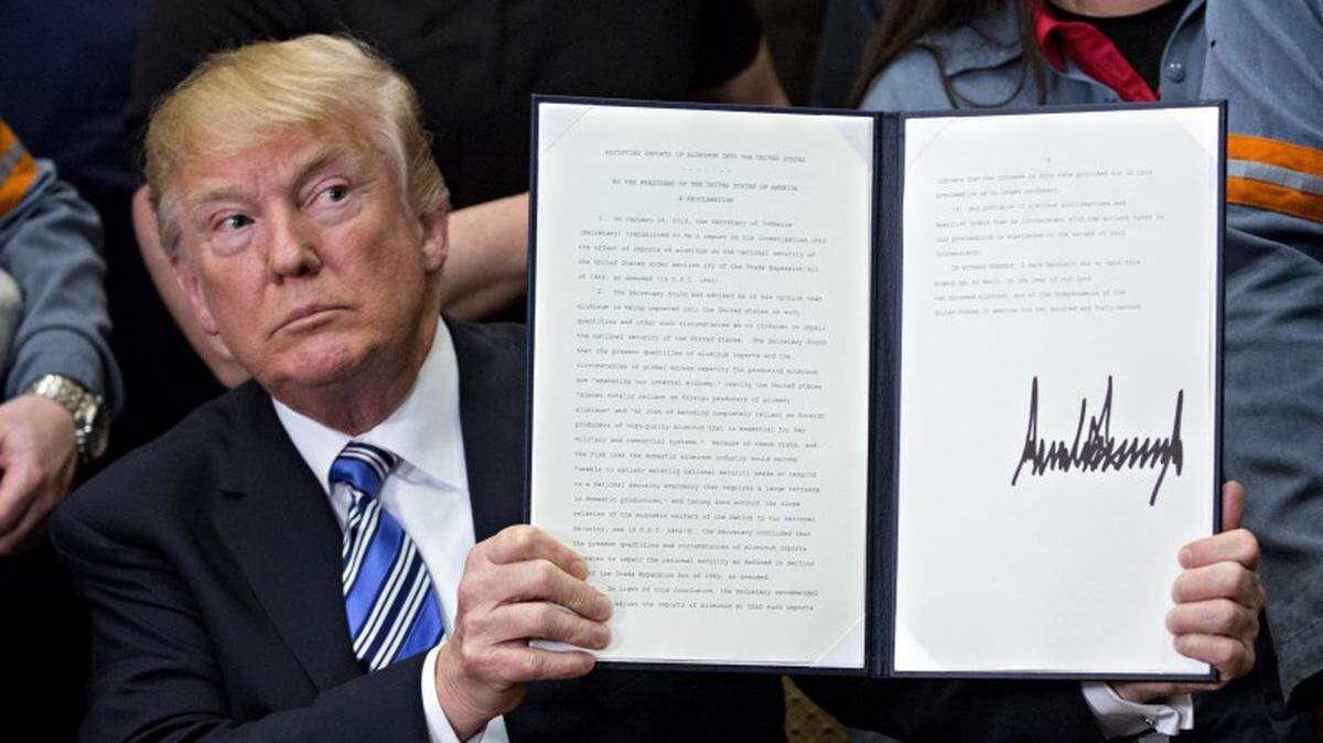 President Trump holds a proclamation, signed in March 2018, adjusting imports of aluminum into the United States.