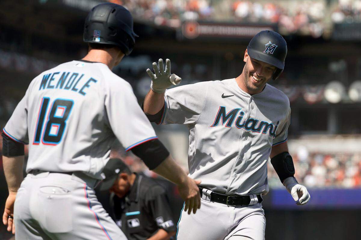 Miami Marlins’ Jacob Stallings, right, celebrates after hitting a two-run home run that scored Joey Wendle (18) during the seventh inning of a baseball game against the San Francisco Giants in San Francisco, Friday, April 8, 2022. (AP Photo/Eric Risberg)
