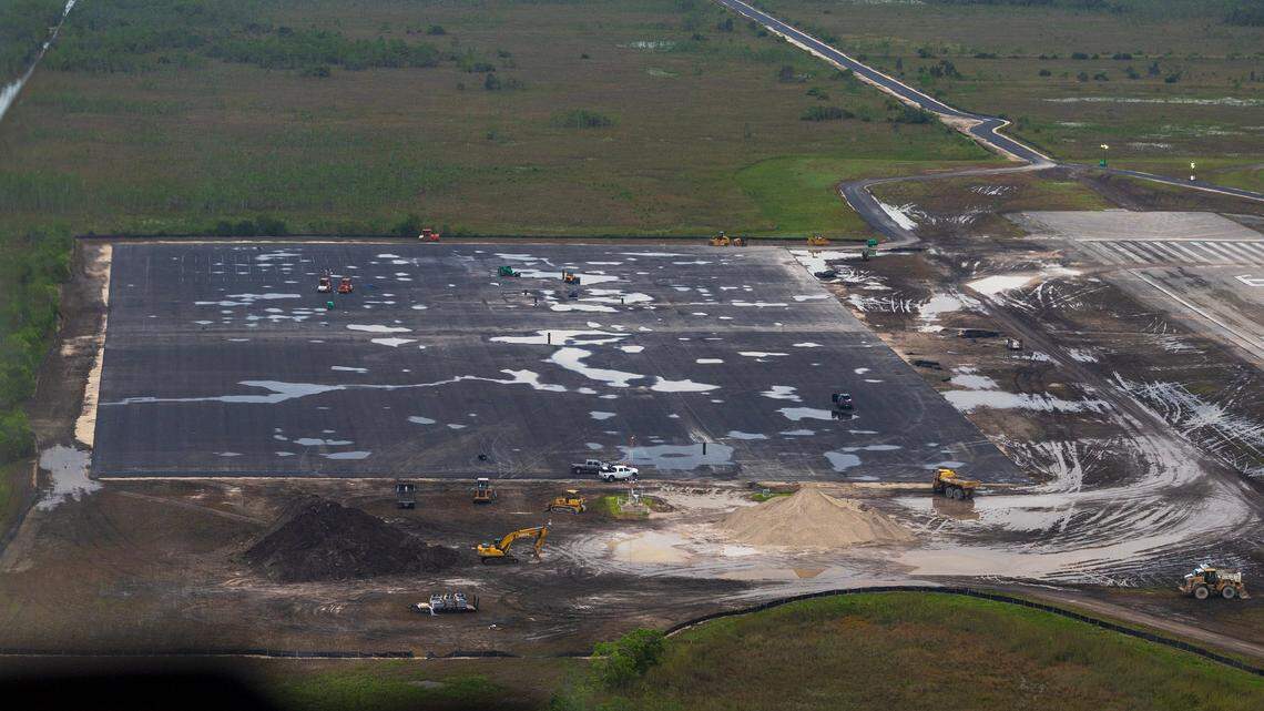 Workers and heavy machinery operate on a vacant lot at the recently opened migrant detention center known as “Alligator Alcatraz,” located at the Dade-Collier Training and Transition Airport in Ochopee, Florida, on Friday, July 4, 2025.