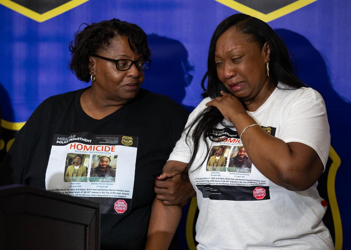 Erica Wilson-Price, right, cries while comforted by Charlotte Rose, left, during a press conference at the Miramar Police Department on Tuesday, Aug. 22, 2023 in Miramar, Fla. The news conference was about the March 2022 double murder of her son, Brent Hart, and his friend Dumas Cherizol-Amilcar.