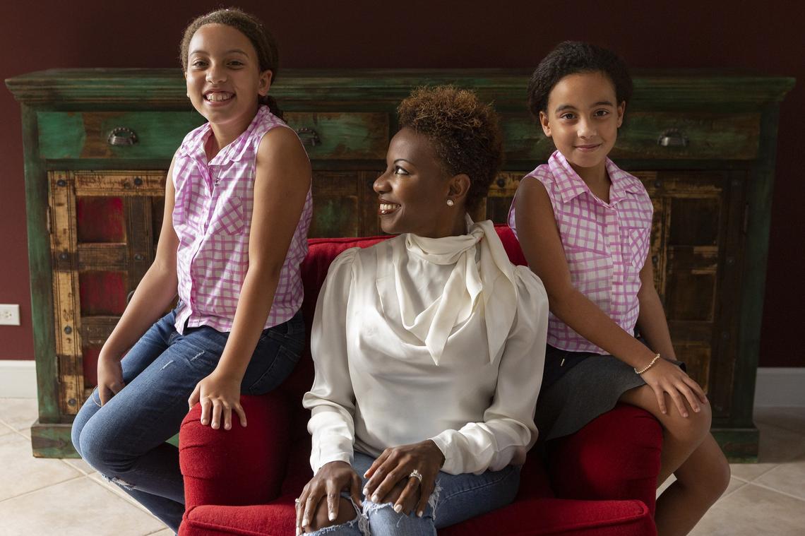 Tamara B. Rodriguez, center, who was diagnosed with breast cancer in 2014, is the author of “Hair to the Queen!” an illustrated children’s book that explains cancer in a simple, compassionate way. Rodriguez was photographed with her two daughters,  Emma, 10, left, and Cora, 8, at their home in Davie.