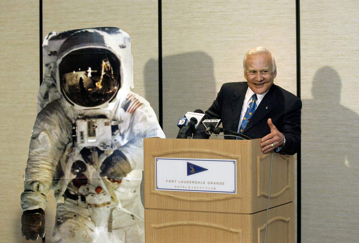 Astronaut Dr. Buzz Aldrin, known for his historic Apollo XI moon walk, is shown in this March 28, 2008 file photo during a light moment as he talks to the press about his professional accomplishments, and his struggles with depression and alcoholism after he returned to Earth. He is speaking next to a cardboard cutout of himself on the moon. Aldrin was in Fort Lauderdale for a fundraiser, “Moonwalkin’ with Buzz,” to boost Broward Housing Solutions, a nonprofit organization that offers housing opportunities for Broward residents with mental health challenges.