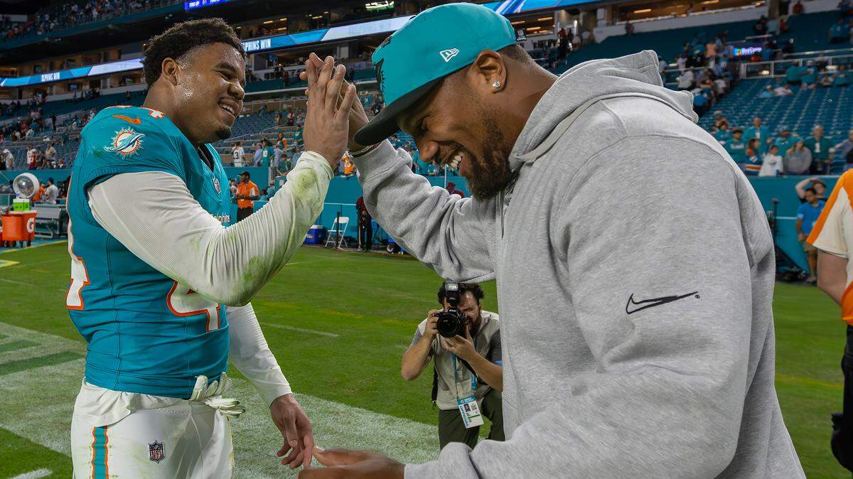 Miami Dolphins linebacker Chop Robinson (44) and linebacker Bradley Chubb (2) celebrate after the Dolphins’ 29-17 victory over the San Francisco 49ers during an NFL game at Hard Rock Stadium on Sunday, Dec. 22, 2024, in Miami Gardens, Florida.