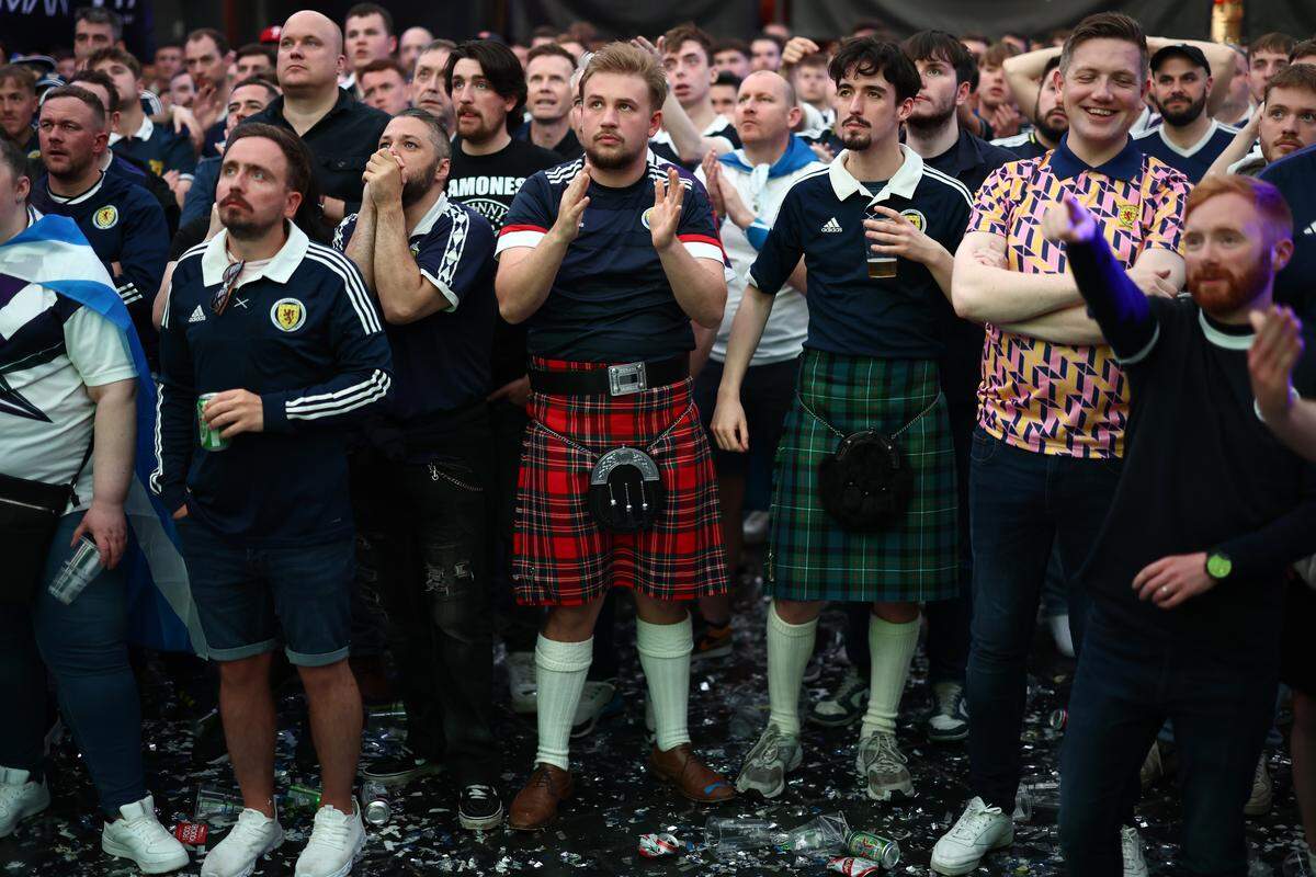 GLASGOW, SCOTLAND - JUNE 19: Scotland fans react at the Glasgow Fan Zone during their UEFA EURO 2024 game on June 19, 2024 in Glasgow, United Kingdom. An estimated 60,000 Tartan Army fans have traveled to Cologne amid storm warnings and public fan zone closures for Scotland's second UEFA EURO 2024 game against Switzerland. (Photo by Jeff J Mitchell/Getty Images)
