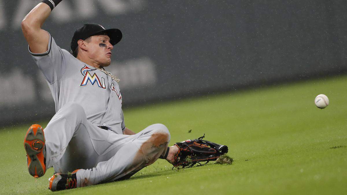 Miami Marlins left fielder Derek Dietrich dives for a ball hit for a double buy Atlanta Braves’ Ozzie Albies during the fourth inning of a baseball game Tuesday, July 31, 2018, in Atlanta. (AP Photo/John Bazemore)