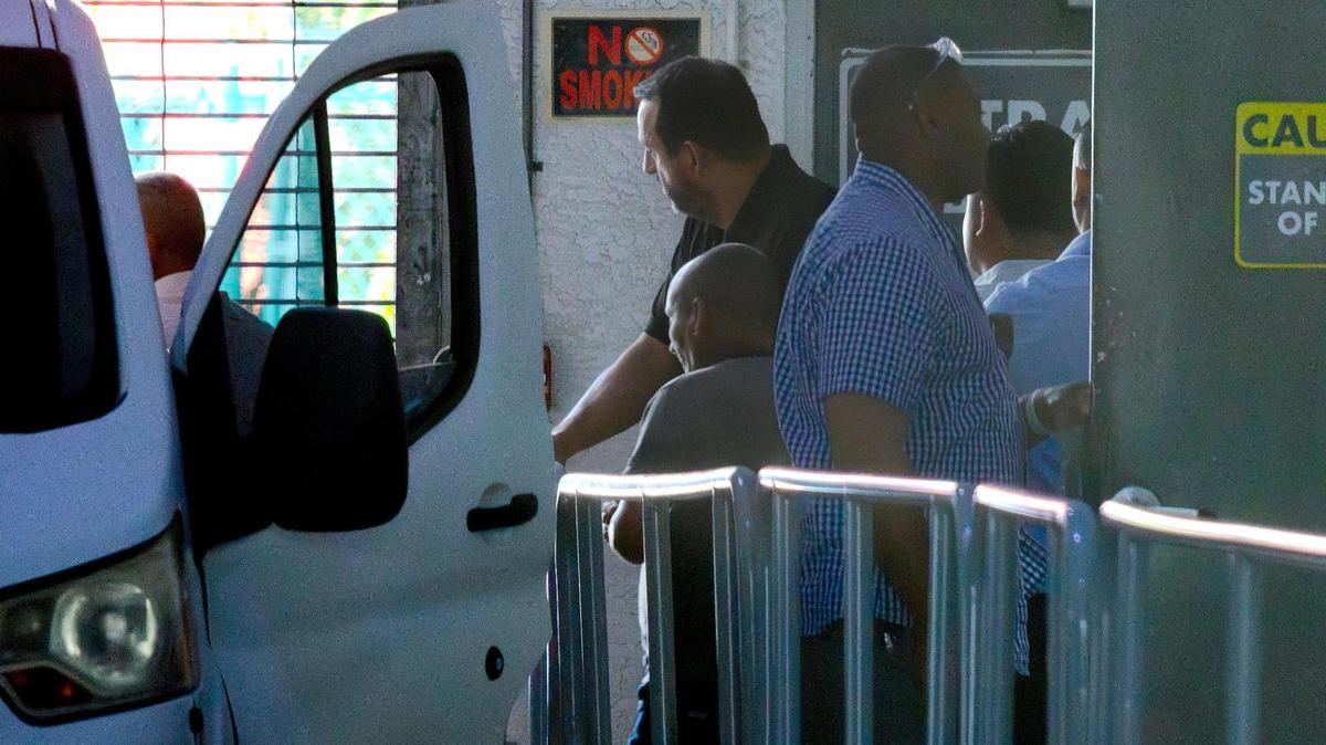 U.S. Immigration and Customs Enforcement (ICE) agents escort a group of men into a van following their arrest outside the Executive Office for Immigration Review (EOIR) at 333 S. Miami Ave. in Miami, Florida, on Wednesday, May 21, 2025.