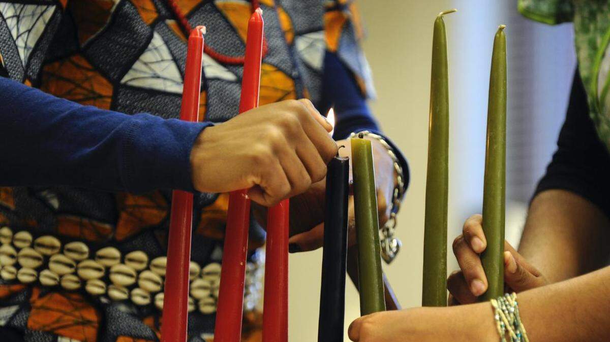 The candles lighted during the week of Kwanzaa represent the seven principles of the observance rooted in African and African-American culture.