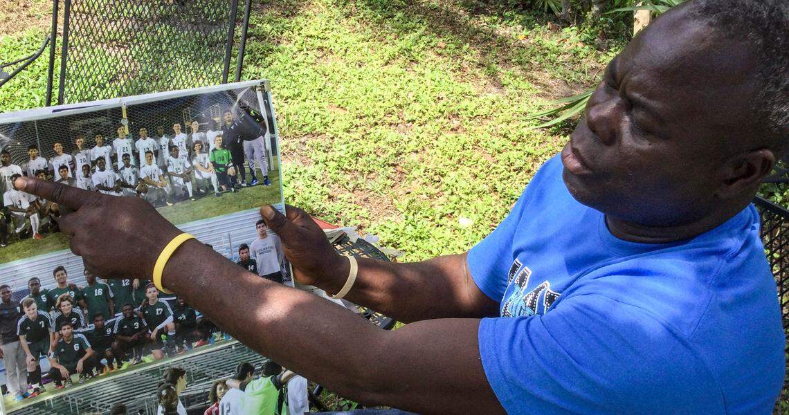 Calice Nalus, 57, of Delray Beach, proudly shows off a newspaper clipping of son John Nalus’ soccer success. John, 21, is missing out on a college scholarship in the U.S. as a result of being “wrongly detained” in the Dominican Republic for nearly a year after he and his two brothers traveled from South Florida on July 29, 2020 for an eight-day visit.