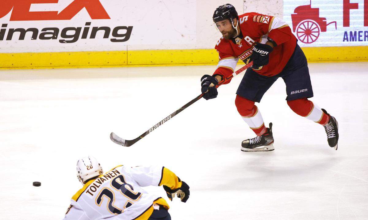 Florida Panthers defenseman Aaron Ekblad (5) passes the puck against Nashville Predators right wing Eeli Tolvanen (28) during the first period of their NHL game at the BB&T Center on Thursday, March 18, 2021 in Sunrise, Fl.