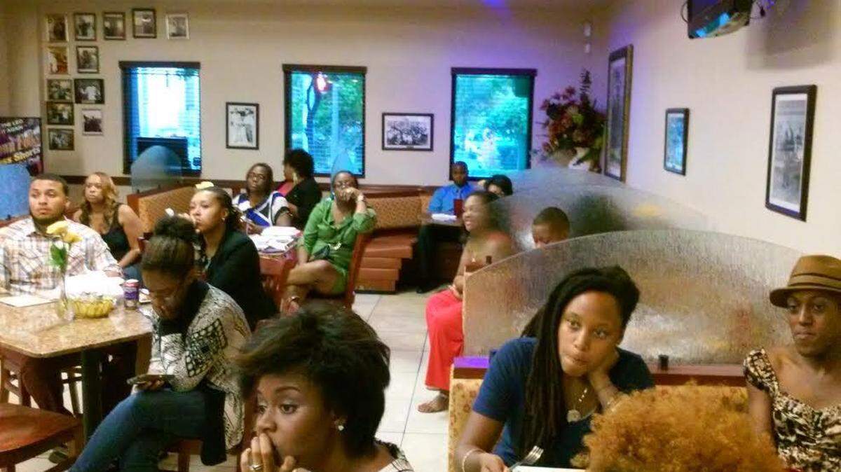 A group of professionals attend a 2014 presentation at Jackson’s Soul Food in Miami on supporting black-owned businesses.