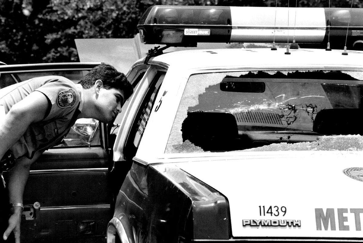 Officers at a investigate a 1990 robbery in Miami-Dade County.