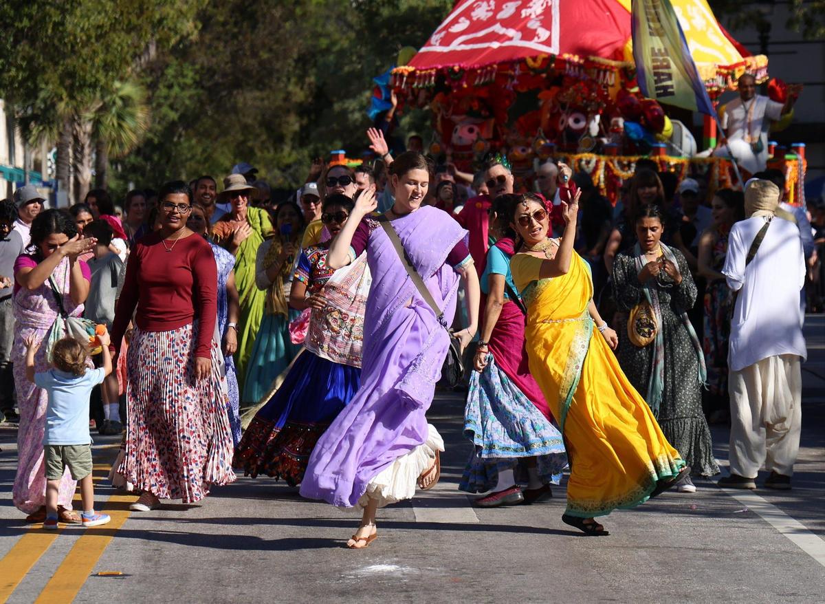 Members of the International Society for Krishna Consciousness (Hare Krishnas) dance down Grand Avenue in this year’s King Mango Strut in Coconut Grove on Jan. 8, 2023.