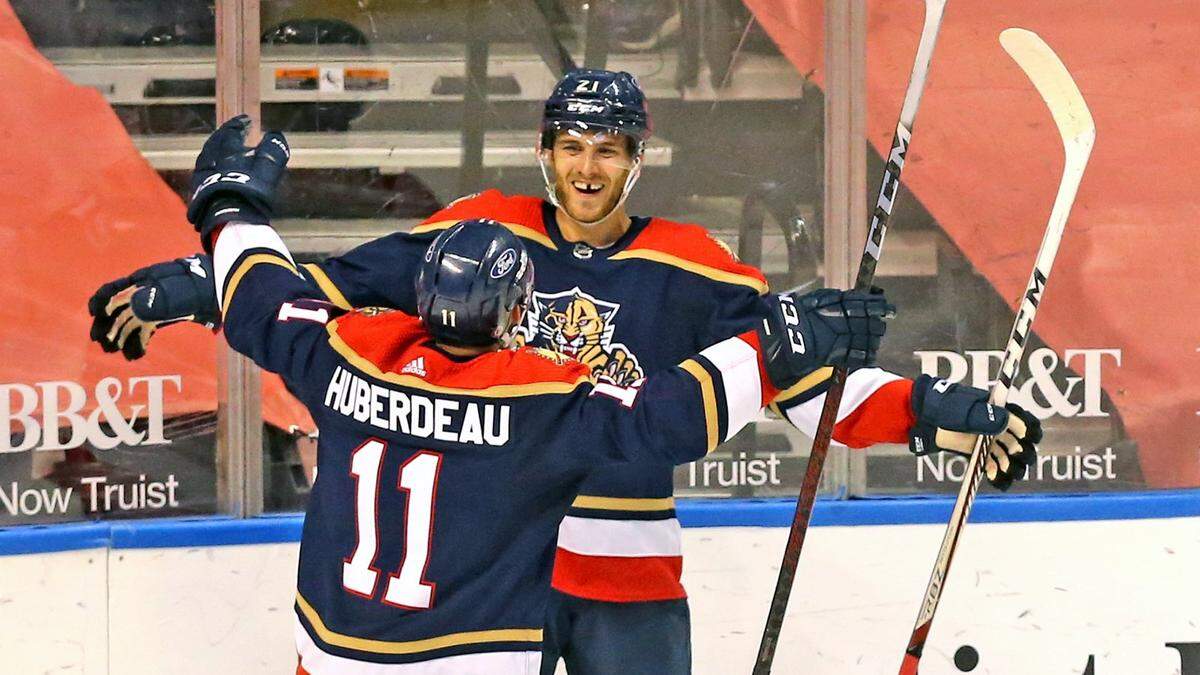 Florida Panthers Jonathan Huberdeau (11) celebrates Alex Wennberg (21) hat trick in the third period as they play the Tampa Bay Lighting at the BB&T Center in Sunrise, Florida, Saturday, May 8, 2021.