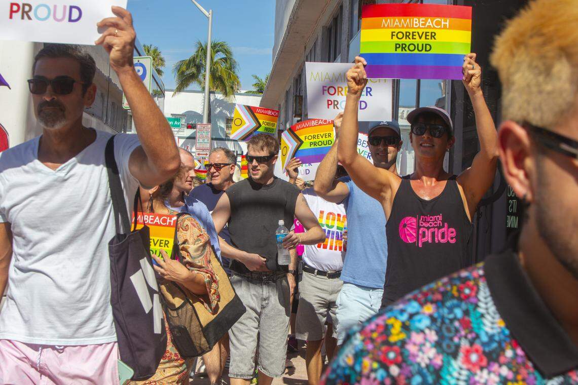 Demonstrators carrying rainbow flags and signs reading ‘Miami Beach Forever Proud’ and ‘Won’t Be Erased’ march during the Forever Proud March on Ocean Drive in Miami Beach, Fla., Sunday, Aug. 31, 2025, held after state officials ordered the removal of the city’s LGBTQ Pride crosswalk.