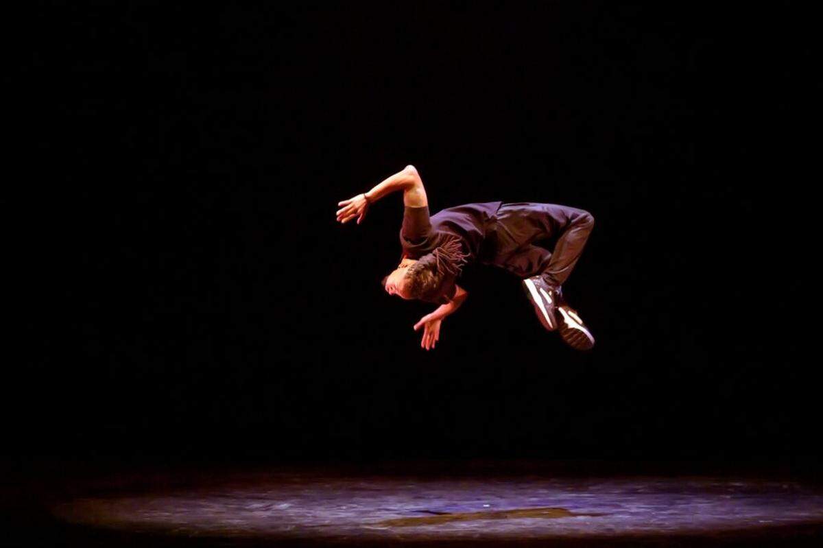 Joshua Culbreath of Renee Harris Puremoement American Street Dance Theater does a solo flip.