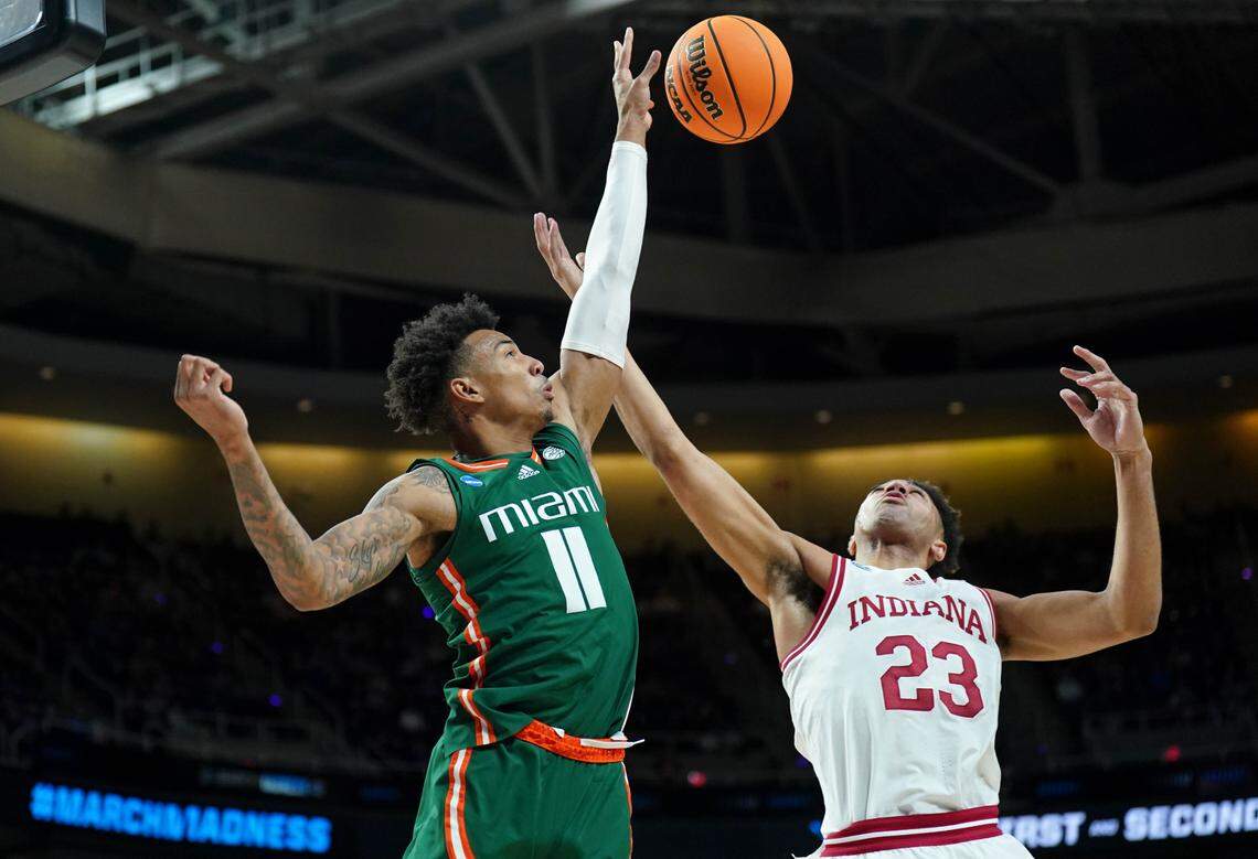 Mar 19, 2023; Albany, NY, USA; Miami (Fl) Hurricanes guard Jordan Miller (11) reaches for the ball against Indiana Hoosiers forward Trayce Jackson-Davis (23) during the first half at MVP Arena. Mandatory Credit: David Butler II-USA TODAY Sports