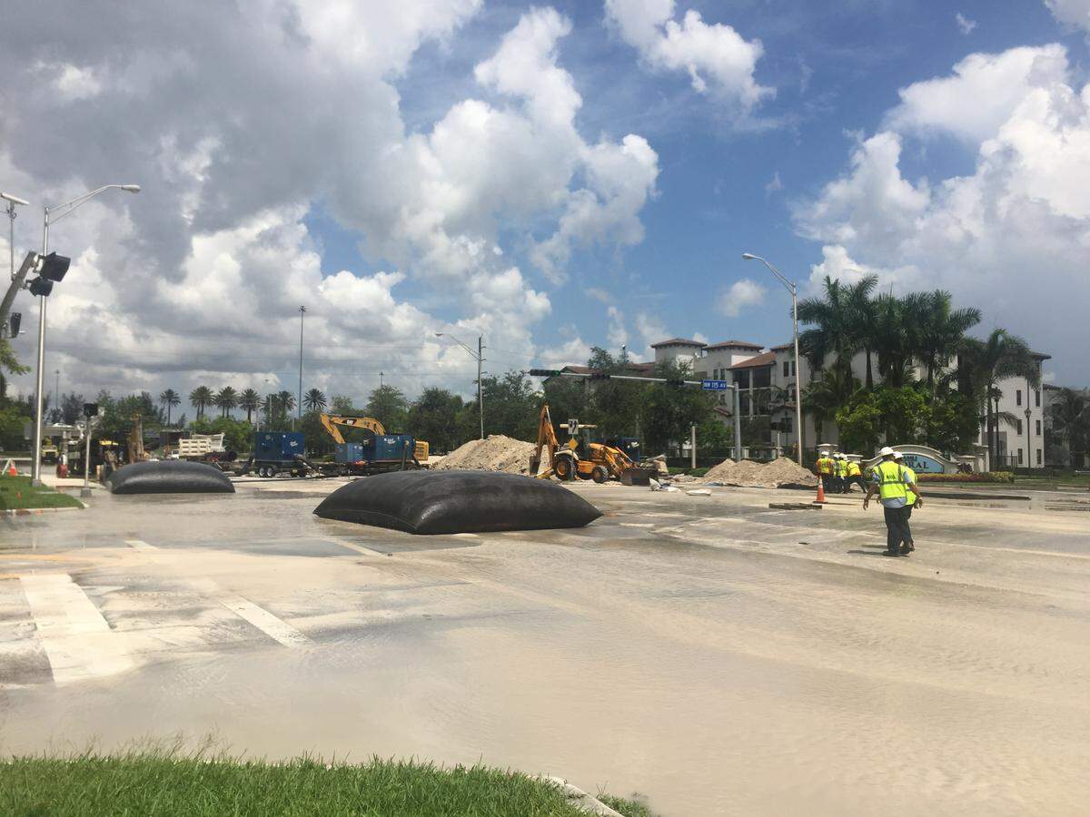 Construction workers attempt to repair the broken pipe on Northwest 41st Street. The street has been blocked off since Monday afternoon causing a traffic nightmare.