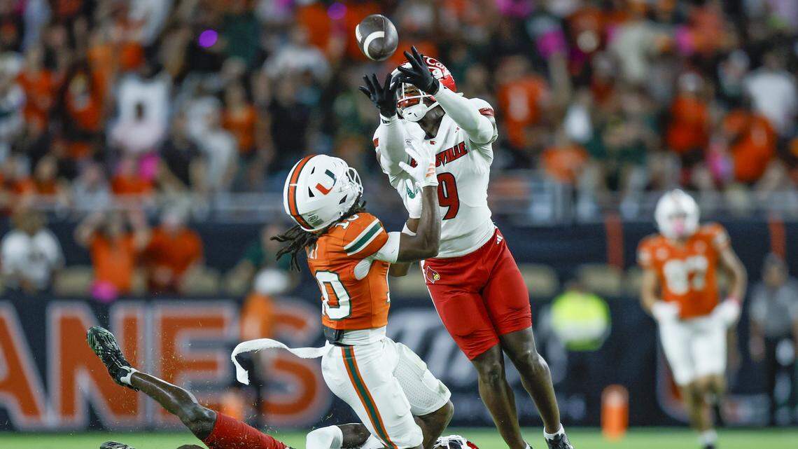 Louisville Cardinals defensive back Antonio Watts (9) intercepts the pass intended for Miami Hurricanes wide receiver Malachi Toney (10) during their NCAA football game at Hard Rock Stadium in Miami Gardens, Florida, on Friday, October 17, 2025.