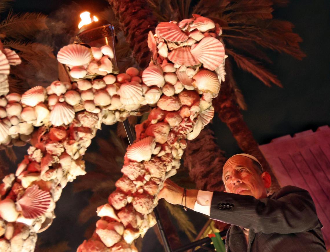 On the first night of Hanukkah, Wayne E. Chaplin, who serves as the President and CEO of Southern Glazer’s Wine & Spirits, lights the first candle to celebrate the Jewish holiday, organized by Chad House at Lincoln Road and Euclid Circle in Miami Beach, Florida, on Thursday, December 7, 2023.
