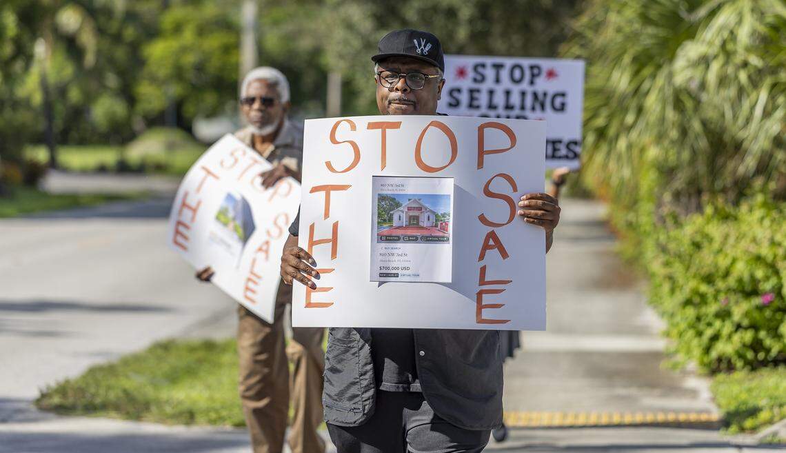 Ives Hicks holds a sign as he gathers with fellow activists to protest outside the House of God Church, Keith Dominion, on Friday, Sept. 19, 2025, in Pompano Beach, Fla. Members of South Florida congregations organized the protest after learning that longtime churches were being sold for what they say is below market value.