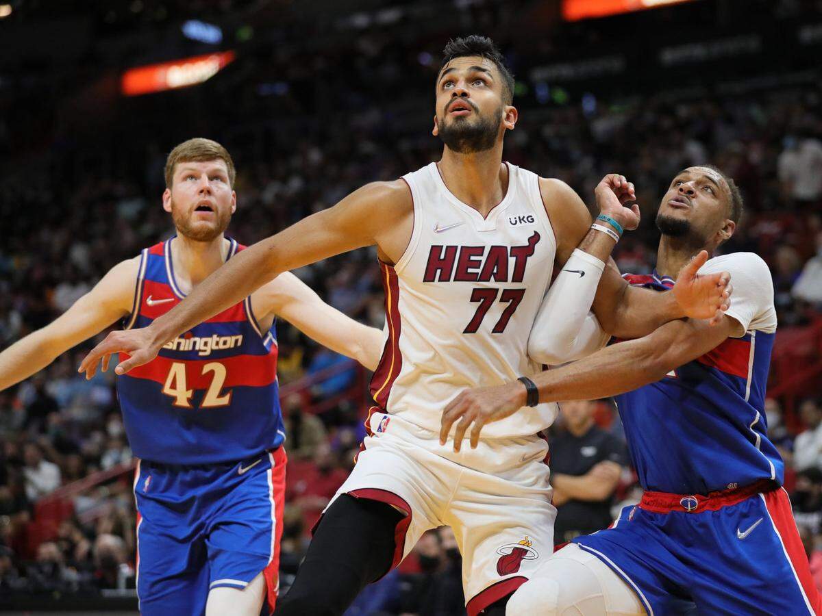Miami Heat center Omer Yurtseven (77) battles with Washington Wizards center Daniel Gafford (21) for the rebound in the second quarter at FTX Arena in Miami on December 28, 2021.