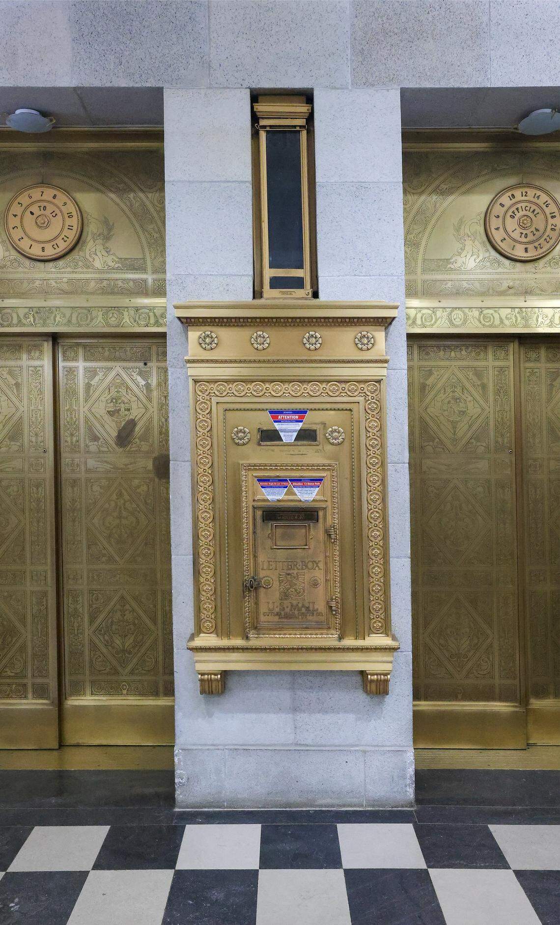 Two of the original etched-bronze elevator doors in the lobby, along with the original bronze mailbox and tube, have been restored inside the historic courthouse in Miami, Florida, on Wednesday, January 14, 2026. The Dade County Courthouse is significant as an excellent example of Neo-Classical architecture. The detailing of the remaining historic interior spaces and features continue to reflect this distinctive style and contributes to a more complete understanding of the historic character of the Courthouse.