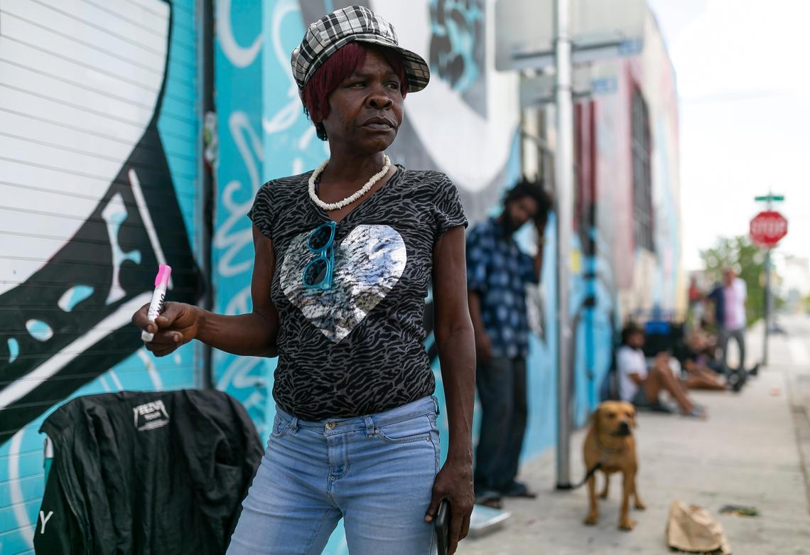 Penny Searcy, 46, who is currently living in her car, holds a portable hand sanitizer, distributed to homeless people to help protect themselves against the coronavirus.