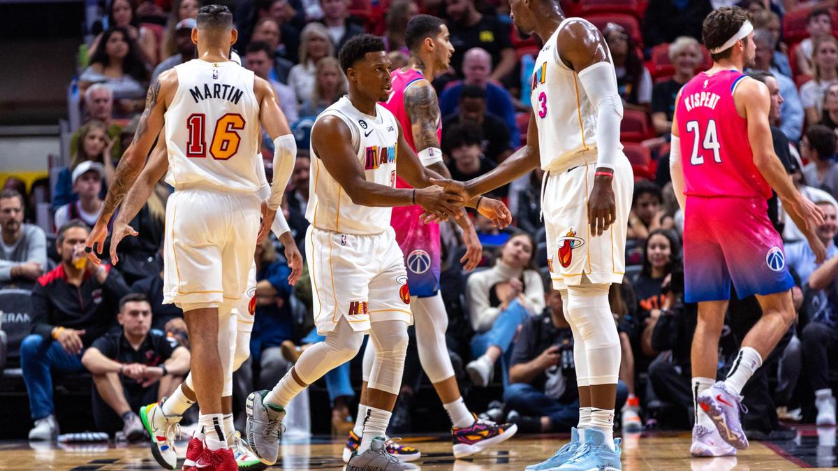 Miami Heat point guard Kyle Lowry (7) reacts with center Bam Adebayo (13) during the first quarter of an NBA game against the Washington Wizards at FTX Arena in Downtown Miami, Florida, on Wednesday, November 23, 2022.