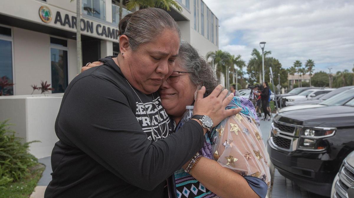 RaeAnn West (L) hugs her friend Susan Isaacs (R) after a press conference at the Miami Gardens Police Department on Friday, Feb. 9, 2024.