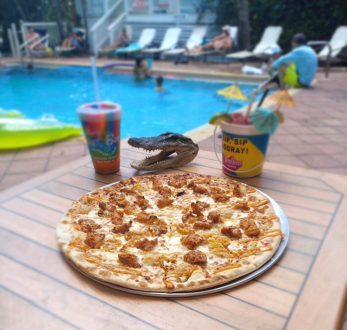 “The Florida Man” pizza at the World Famous Tiki Bar at Lighthouse Resort Inn & Suites in Fort Myers Beach is made with homemade “special Trailer Sauce” and is topped with fried gator and banana peppers.