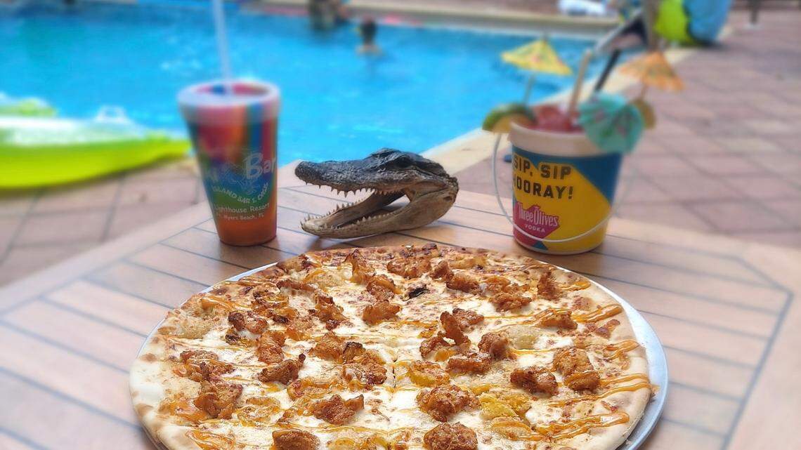 “The Florida Man” pizza at the World Famous Tiki Bar at Lighthouse Resort Inn & Suites in Fort Myers Beach is made with homemade “special Trailer Sauce” and is topped with fried gator and banana peppers.