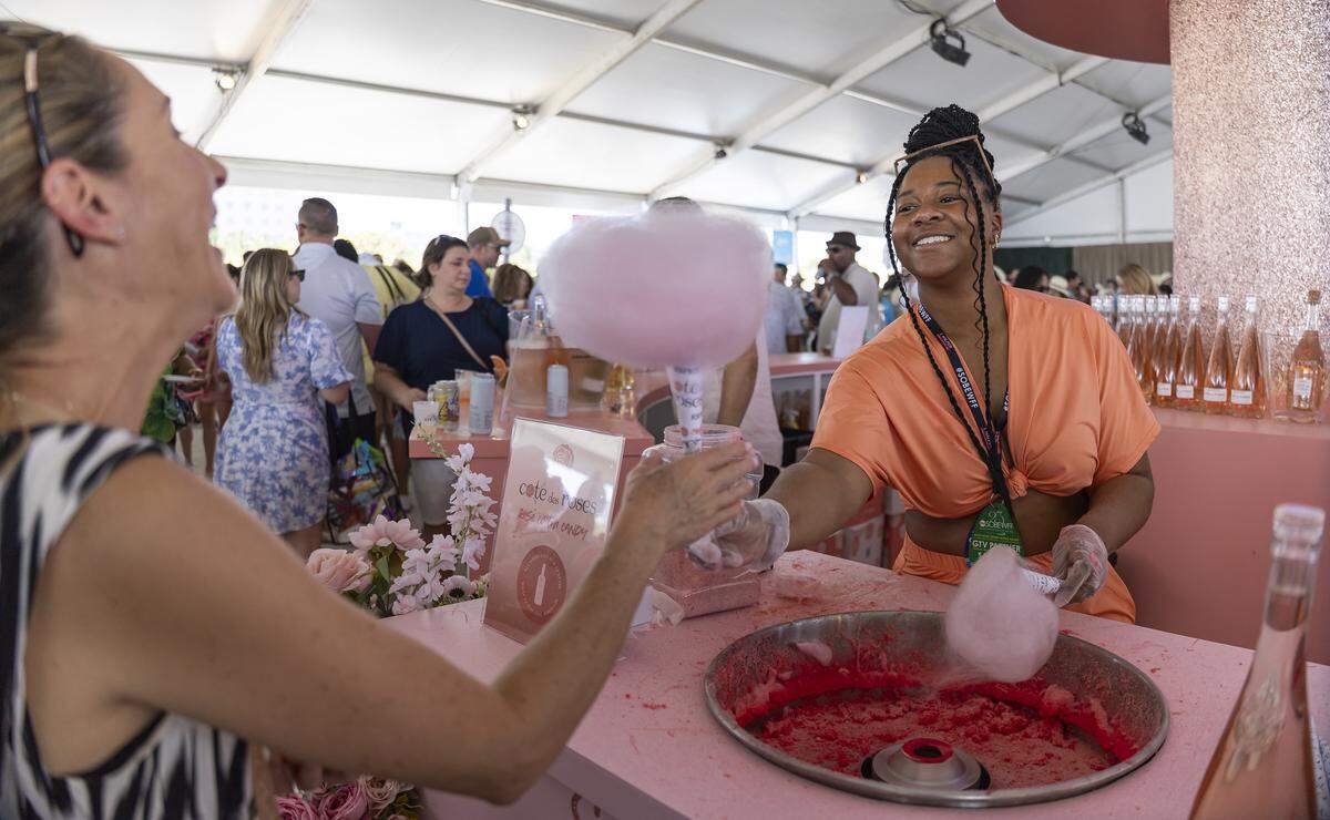 Kyla Odom, a Twirl Associate at Twirl Cotton Candy, prepares cotton candy for a guest inside the Goya Foods' Grand Tasting Village during the Food Network South Beach Wine & Food Festival on Saturday, Feb. 21, 2026, in Miami Beach, Fla.