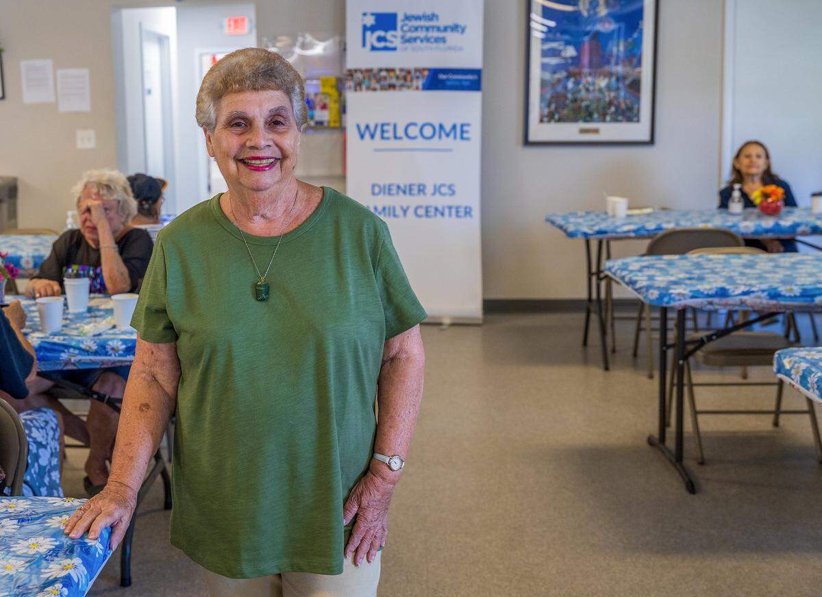 Caroline Dahan, a Miami Beach resident for the last 50 years posed during lunch time, at the Diener JCS Family Center in Miami Beach, where members received many services including lunch, entertainment, etc all year round that could be affected as JCS is one of over 40 nonprofits that's losing significant funds ($16 million) due to Miami-Dade County budget cuts, on Tuesday, August 12, 2025.