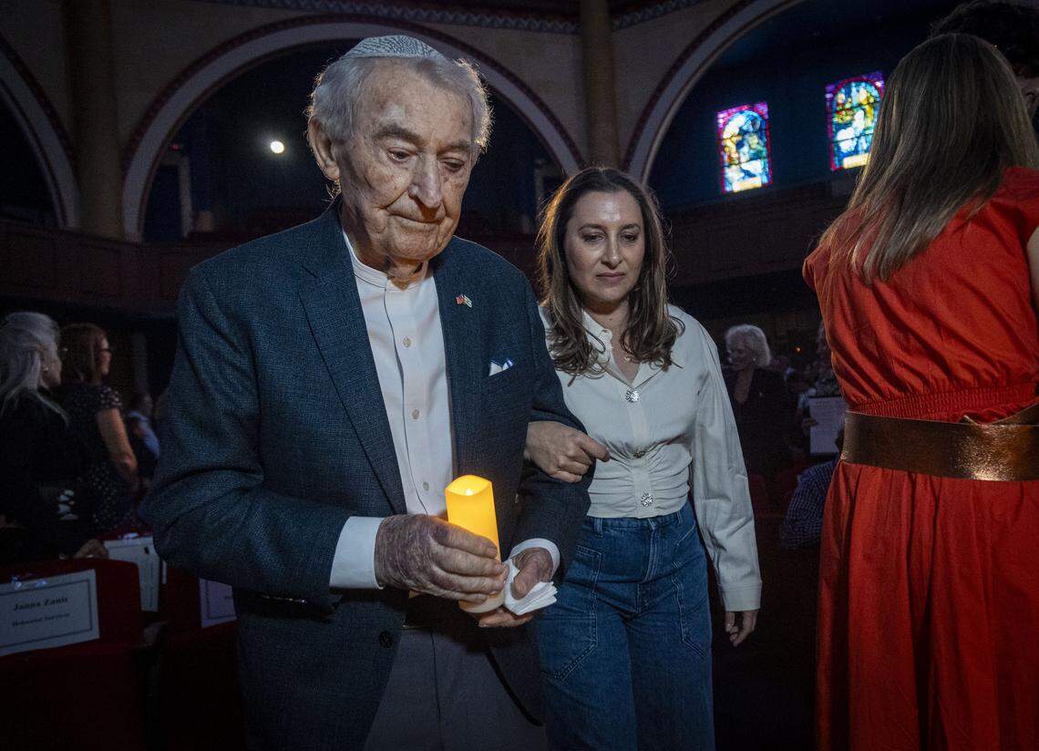 On April 27, 2025, Holocaust survivor David Schaecter, left, carried a candle as he walked in a procession of Holocaust survivors into a ceremony to Commemorate Yom HaShoah, Holocaust Remembrance Day, at Temple Emanu-El in Miami Beach.